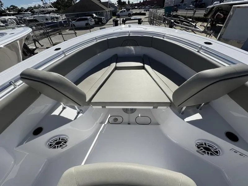 Slide: The Image of 2025 Sportsman Open 282 boat interior with cushioned seating and speakers. - 11