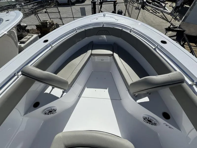 Slide: The Image of 2025 Sportsman Open 282 boat interior with cushioned seating and speakers. - 12