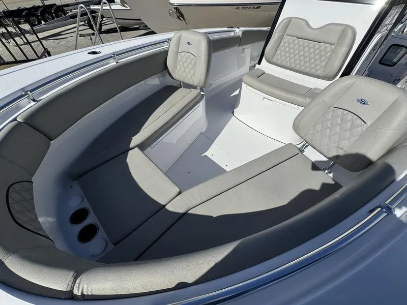 Slide: The Image of 2025 Sportsman Open 282 boat interior with cushioned seating and cup holders. - 14