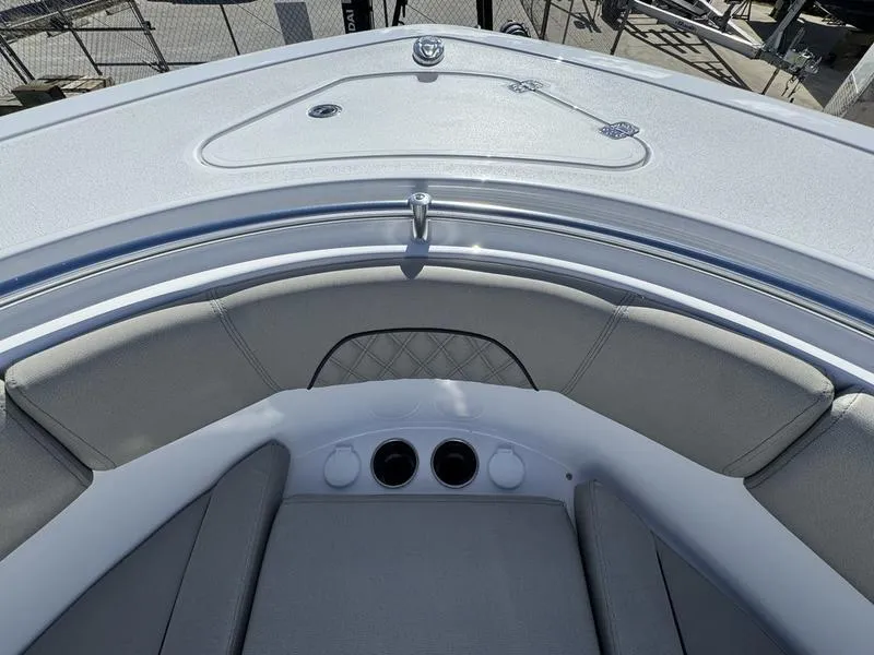 Slide: The Image of 2025 Sportsman Open 282 boat interior with cushioned seating and storage compartment. - 17
