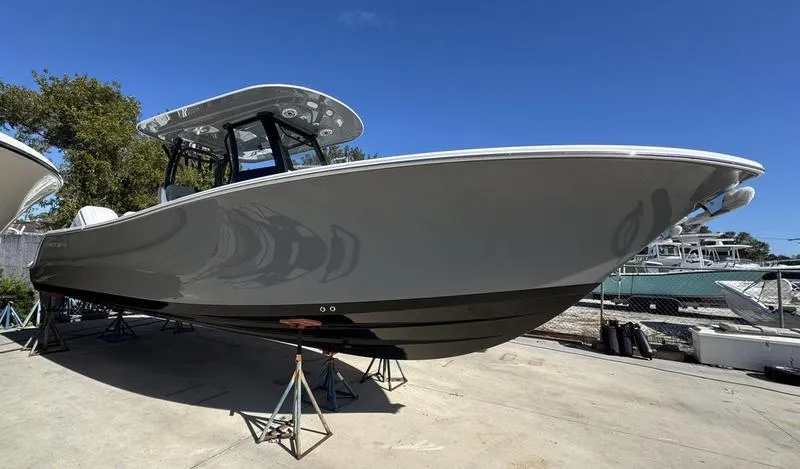 Slide: The Image of 2025 Sportsman Open 282 boat on display, sleek design, parked outdoors. - 2
