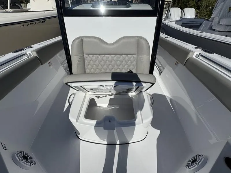 Slide: The Image of 2025 Sportsman Open 282 boat interior with cushioned seating and storage compartment. - 20