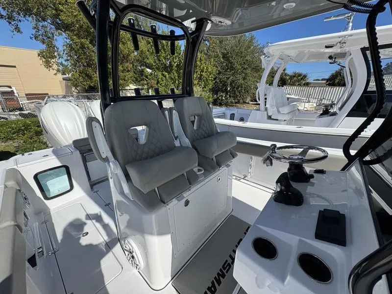 Slide: The Image of 2025 Sportsman Open 282 boat interior with dual seats and steering console. - 27