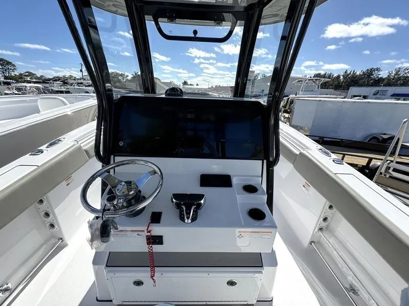 Slide: The Image of 2025 Sportsman Open 282 boat cockpit with steering wheel and control panel. - 29