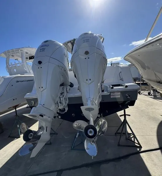 Slide: The Image of 2025 Sportsman Open 282 boat with dual outboard engines in a marina setting. - 3