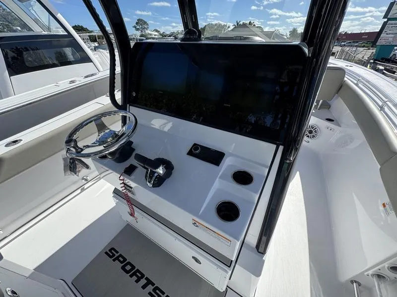 Slide: The Image of 2025 Sportsman Open 282 boat console with steering wheel and controls. - 31