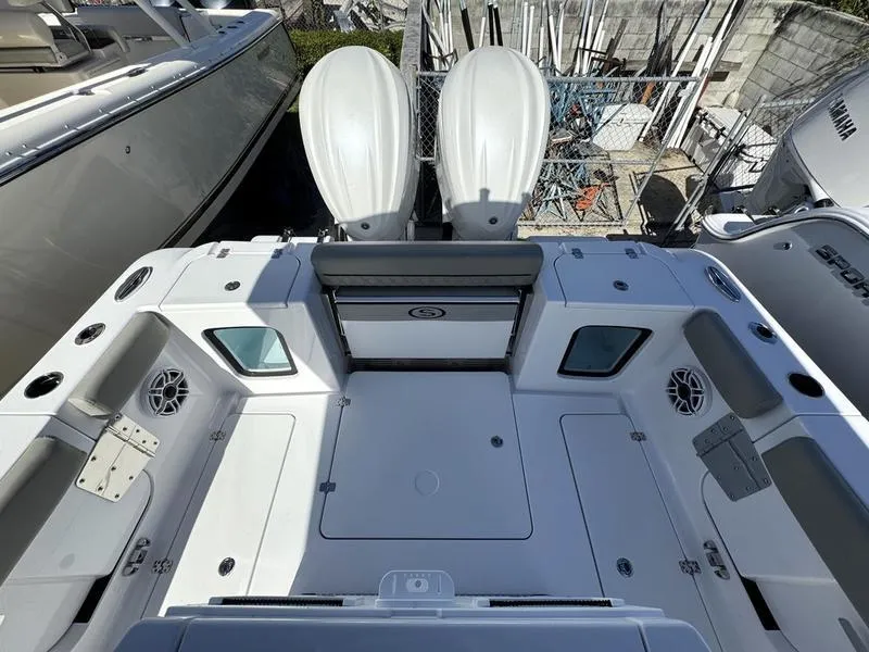 Slide: The Image of 2025 Sportsman Open 282 boat deck with dual engines, spacious seating, and storage compartments. - 34