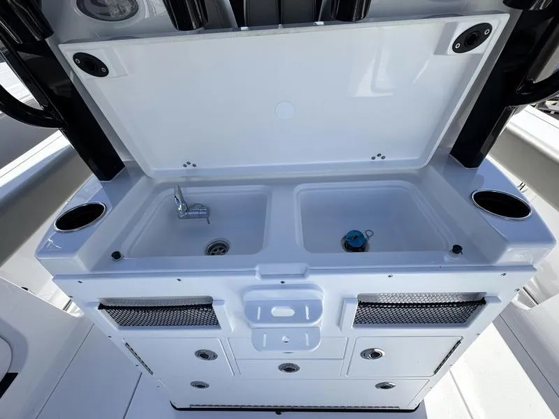 Slide: The Image of 2025 Sportsman Open 282 boat sink and storage area with dual basins. - 38