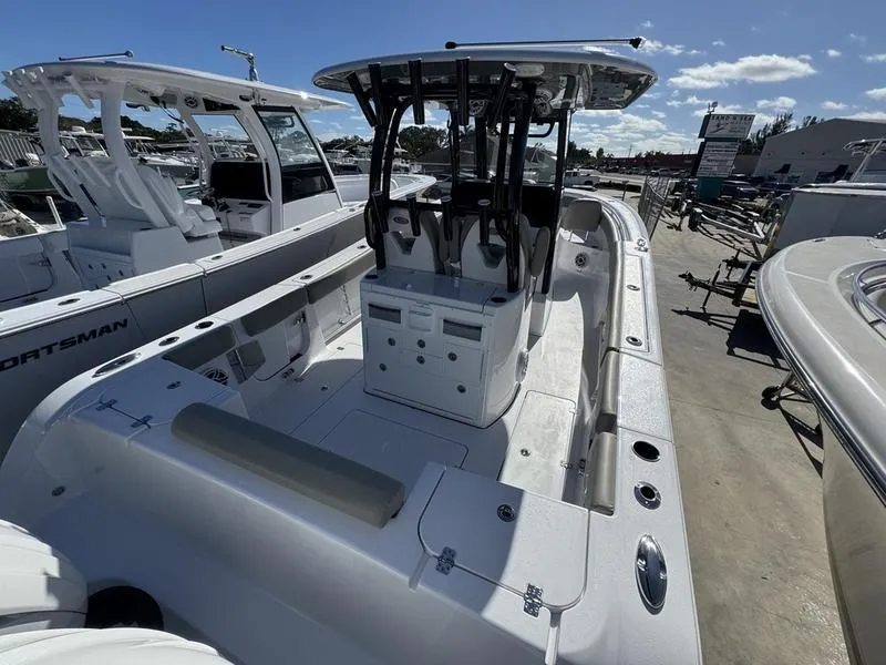 Slide: The Image of 2025 Sportsman Open 282 boat, sleek design, spacious deck, modern features, docked under clear sky. - 4