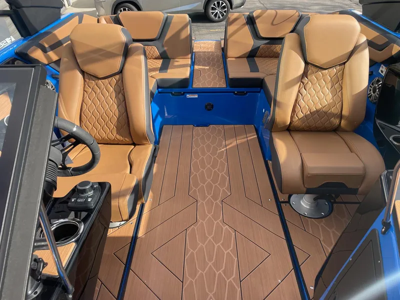 Slide: The Image of 2025 Yamaha Boats 222XE interior with tan seats and blue accents. - 11