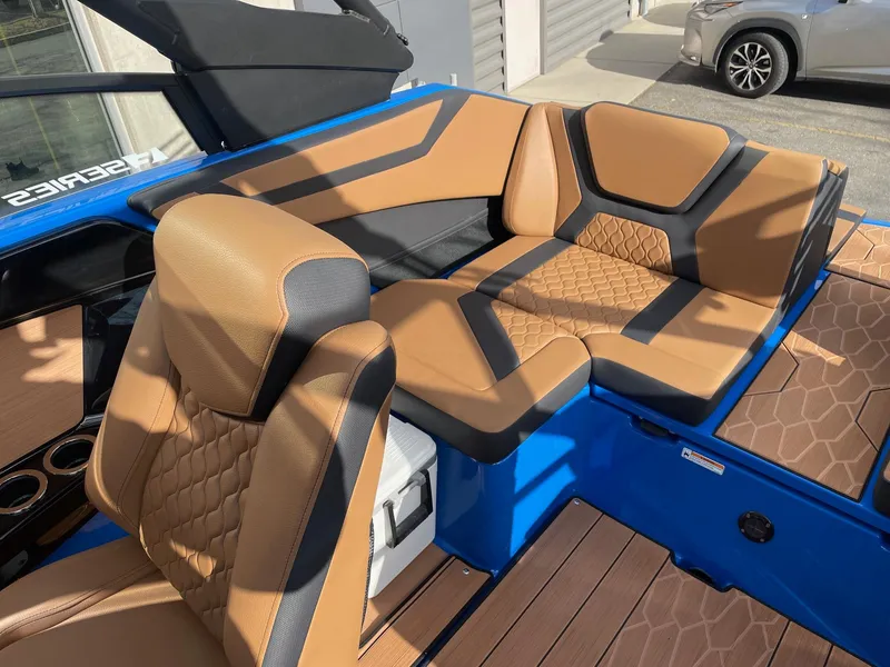 Slide: The Image of 2025 Yamaha Boats 222XE interior with tan and black seating, blue accents. - 6