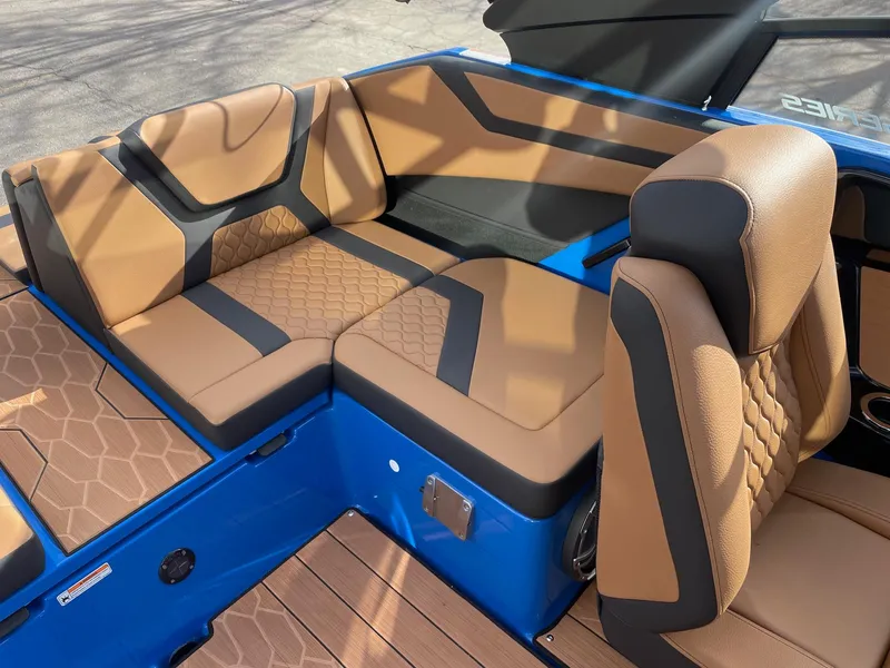 Slide: The Image of 2025 Yamaha Boats 222XE interior with tan and black seating, blue accents. - 8