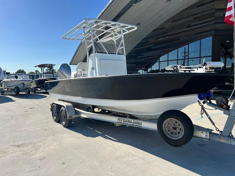 Slide: The Image of 2011 Gravois 22 Bay boat on trailer outside a modern building. - 2
