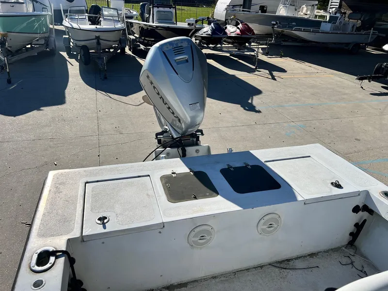 Slide: The Image of 2011 Gravois 22 Bay boat with Honda outboard motor in a marina setting. - 3