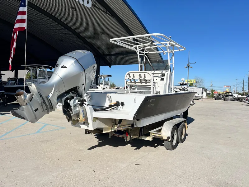 Slide: The Image of 2011 Gravois 22 Bay boat on trailer with outboard motor, parked outdoors. - 7