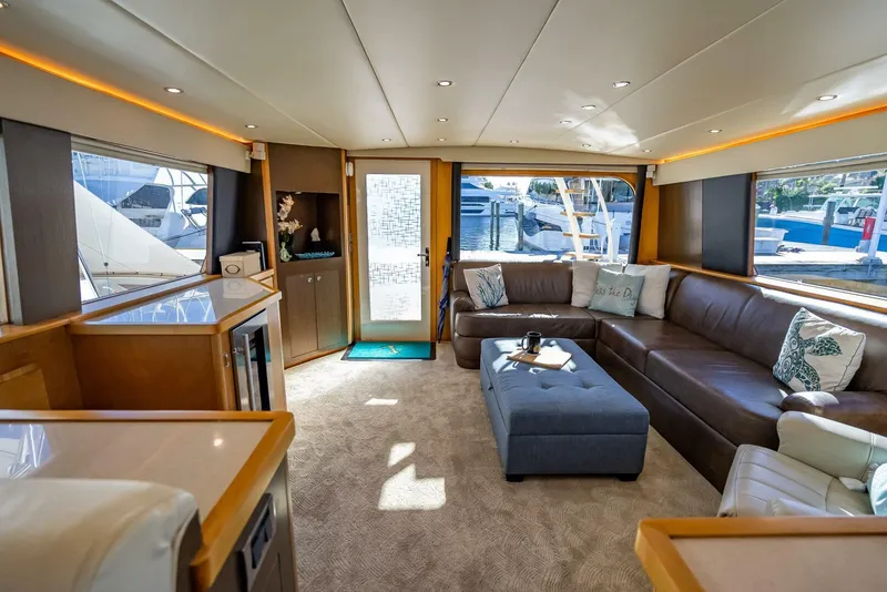 Slide: The Image of Luxurious interior of 1989 Hatteras 65 Enclosed Bridge yacht with plush seating and modern decor. - 15