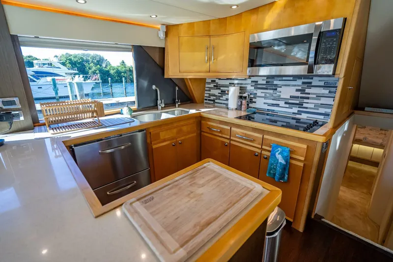 Slide: The Image of Modern kitchen interior of 1989 Hatteras 65 Enclosed Bridge yacht with sleek appliances. - 18