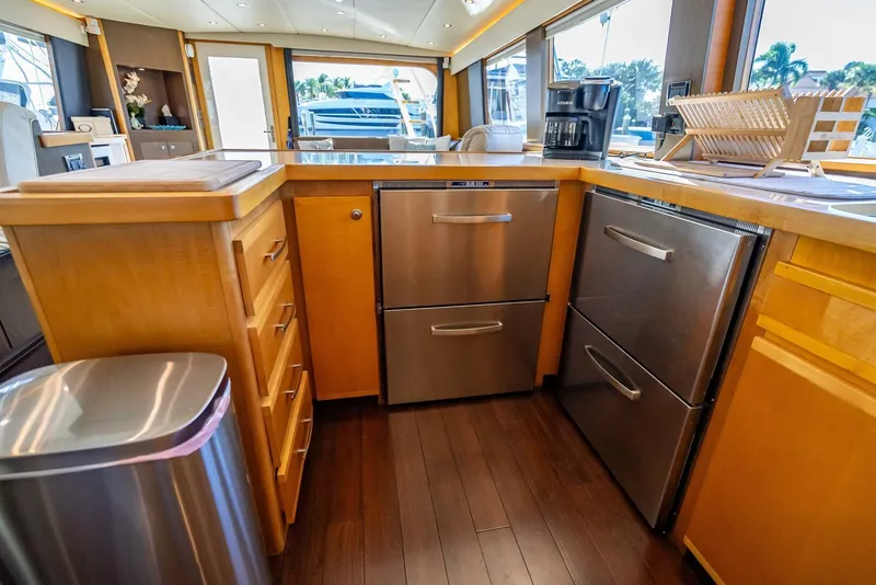 Slide: The Image of Modern kitchen interior on 1989 Hatteras 65 Enclosed Bridge yacht with stainless steel appliances. - 19