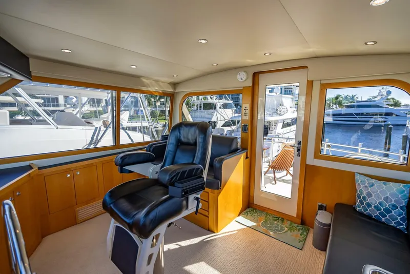 Slide: The Image of Interior of 1989 Hatteras 65 Enclosed Bridge yacht with leather seating and large windows. - 23