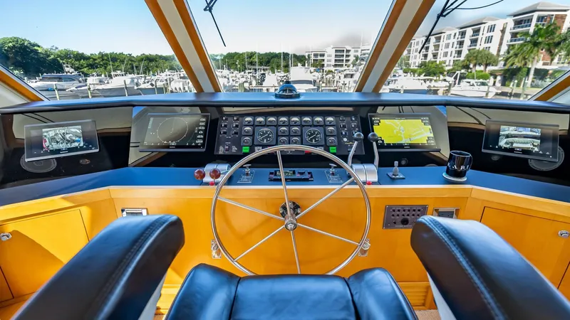Slide: The Image of Interior view of 1989 Hatteras 65 Enclosed Bridge yacht cockpit with navigation controls. - 26