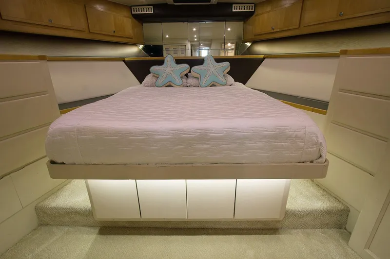 Slide: The Image of Luxurious bedroom interior of 1989 Hatteras 65 Enclosed Bridge yacht with star-shaped pillows. - 27