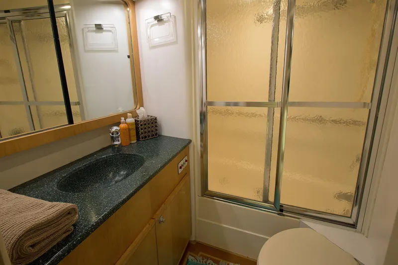 Slide: The Image of Bathroom interior of 1989 Hatteras 65 Enclosed Bridge yacht with shower and vanity. - 28