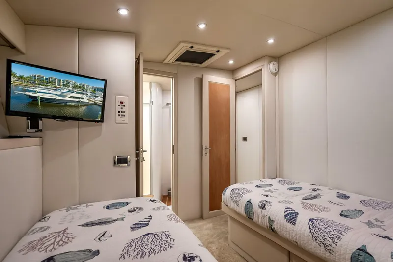 Slide: The Image of Interior of 1989 Hatteras 65 Enclosed Bridge yacht with twin beds and TV. - 30