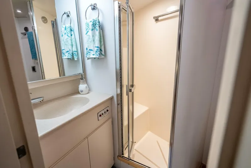 Slide: The Image of Bathroom interior of 1989 Hatteras 65 Enclosed Bridge yacht with shower and sink. - 31