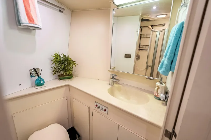Slide: The Image of Luxurious bathroom in 1989 Hatteras 65 Enclosed Bridge yacht, featuring modern amenities. - 35