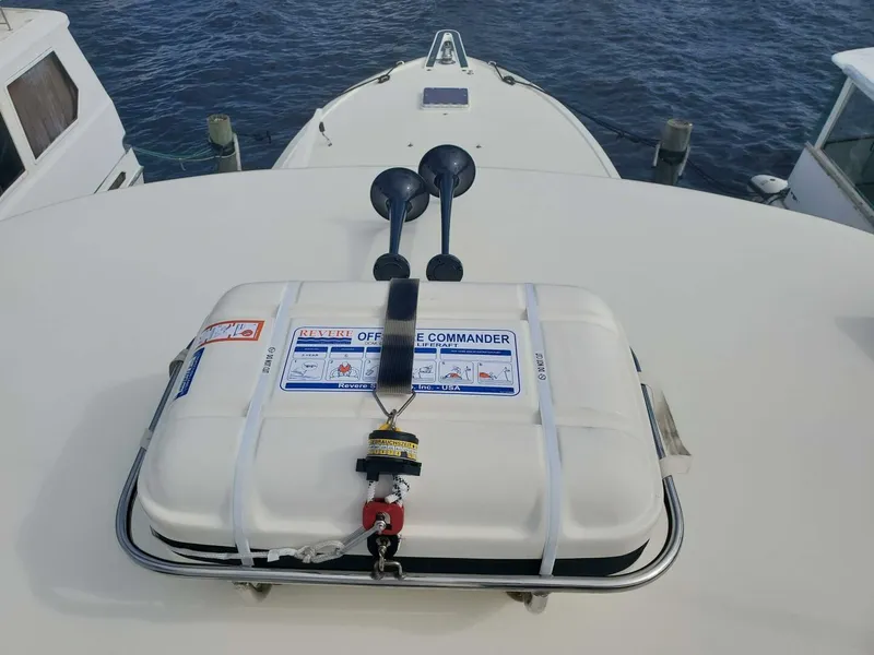 Slide: The Image of Life raft on 1989 Hatteras 65 Enclosed Bridge yacht deck, near water. - 40