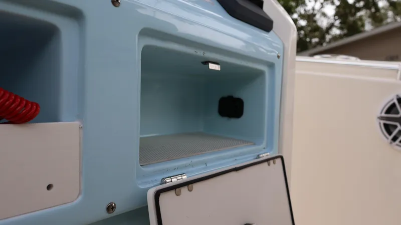 Slide: The Image of 2023 Cobia 280 Center Console storage compartment with open hatch. - 11