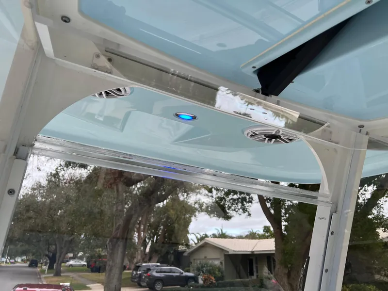 Slide: The Image of 2023 Cobia 280 Center Console boat with blue LED lights and speakers. - 12