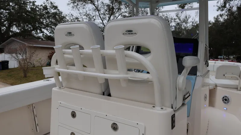Slide: The Image of 2023 Cobia 280 Center Console boat interior with rod holders and seating. - 24