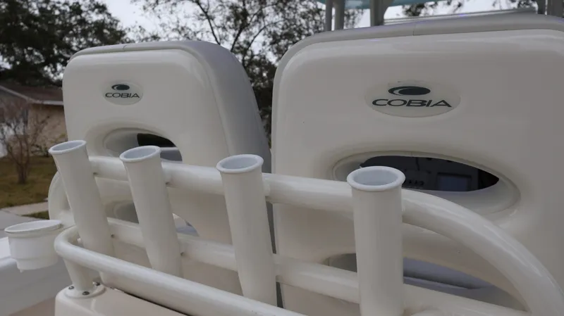 Slide: The Image of 2023 Cobia 280 Center Console boat seats with rod holders. - 25