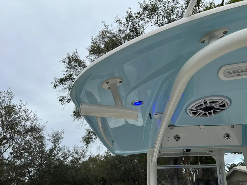 Slide: The Image of 2023 Cobia 280 Center Console boat with blue LED lights and speaker system. - 26