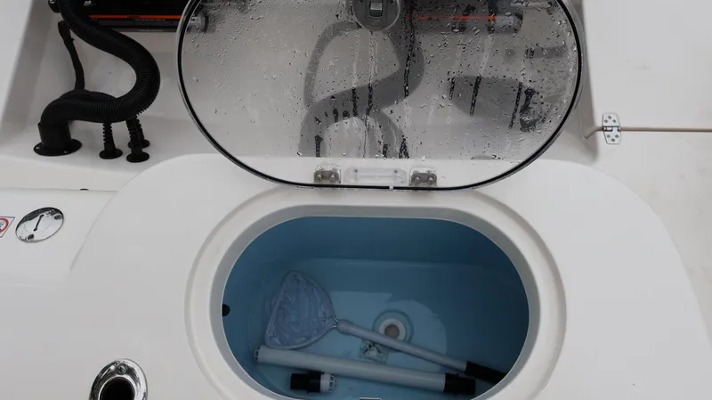 Slide: The Image of 2023 Cobia 280 Center Console livewell with fishing gear inside. - 28