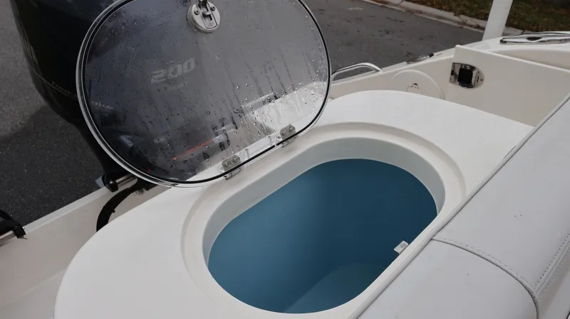 Slide: The Image of 2023 Cobia 280 Center Console boat with open livewell and Yamaha 200 engine. - 29