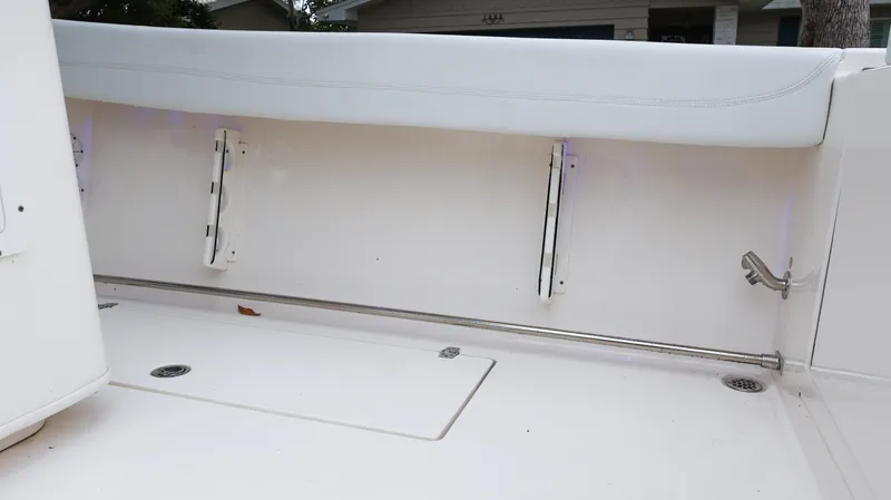 Slide: The Image of 2023 Cobia 280 Center Console boat interior with white seating and storage compartments. - 31