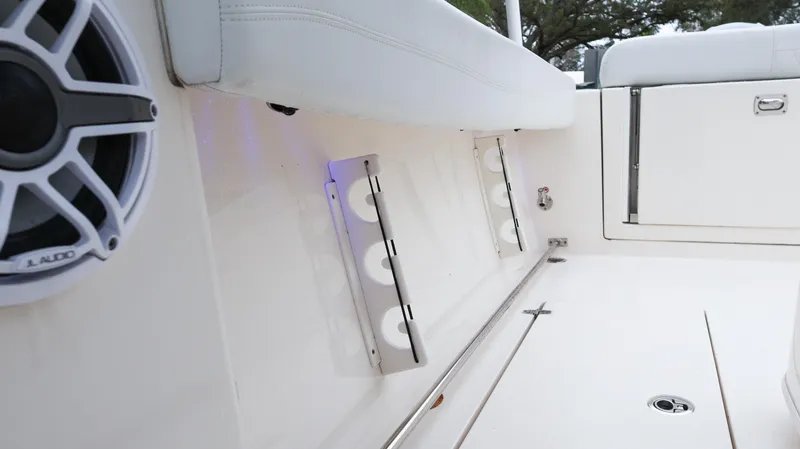 Slide: The Image of 2023 Cobia 280 Center Console boat interior with speaker and rod holders. - 32