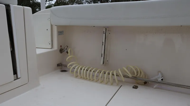 Slide: The Image of 2023 Cobia 280 Center Console boat interior with coiled hose and seating. - 36