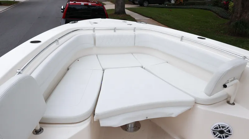 Slide: The Image of 2023 Cobia 280 Center Console boat with spacious white seating area. - 43