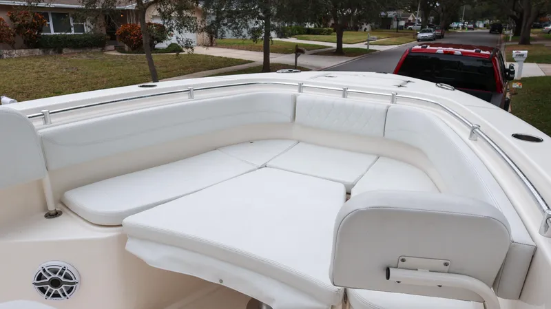 Slide: The Image of 2023 Cobia 280 Center Console boat with spacious white seating area. - 44