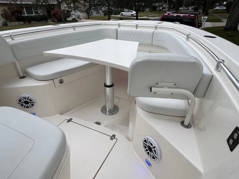 Slide: The Image of 2023 Cobia 280 Center Console boat with white seating and table in the bow area. - 46