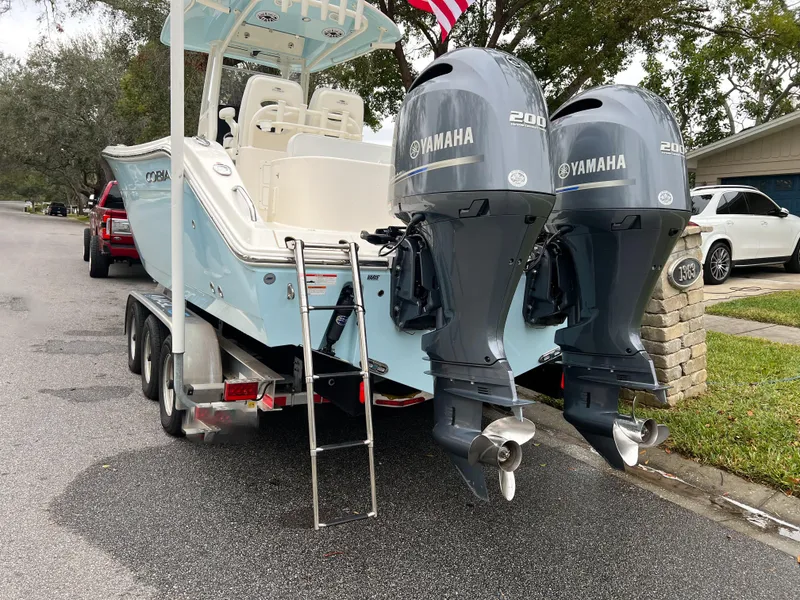 Slide: The Image of 2023 Cobia 280 Center Console boat with dual Yamaha 200 engines on a trailer. - 5