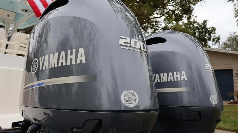 Slide: The Image of 2023 Cobia 280 Center Console with dual Yamaha 200 engines, outdoor setting. - 6