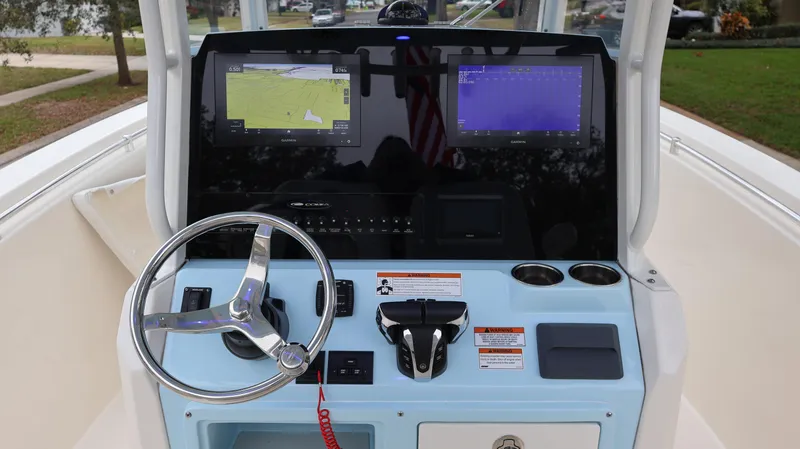 Slide: The Image of 2023 Cobia 280 Center Console dashboard with dual navigation screens and steering wheel. - 8