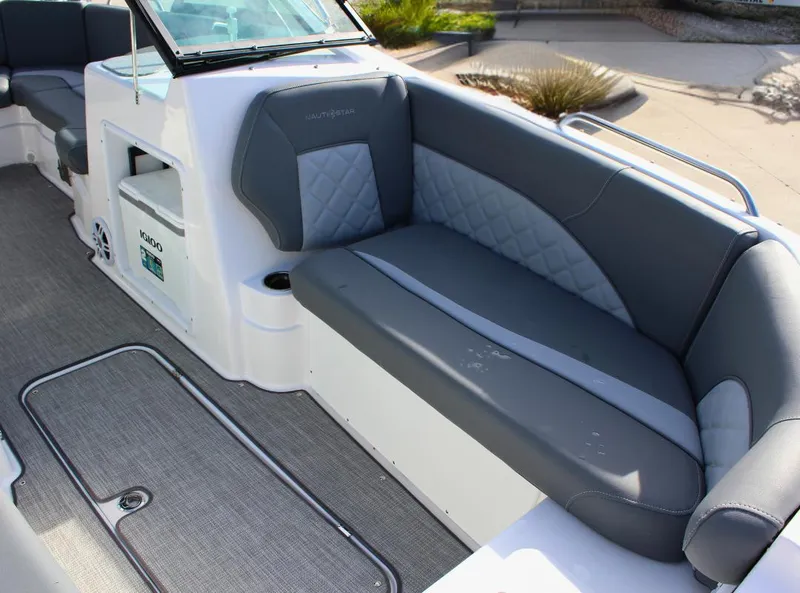 Slide: The Image of 2024 NauticStar DC Deck boat interior with gray seating and modern design. - 12