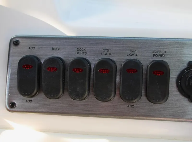 Slide: The Image of Control panel of 2024 NauticStar DC Deck boat with labeled switches. - 17