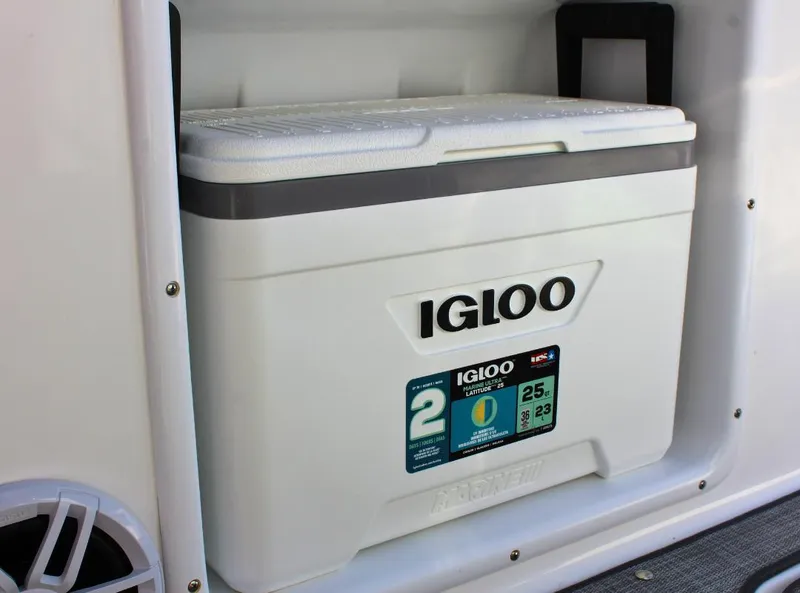 Slide: The Image of Igloo cooler on 2024 NauticStar DC Deck boat, white compartment storage. - 21