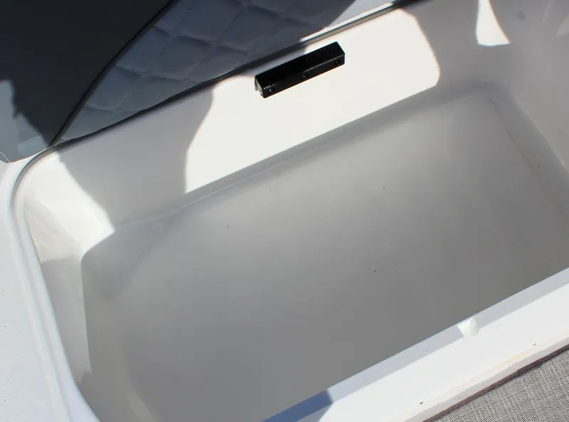 Slide: The Image of 2024 NauticStar DC Deck boat storage compartment, open and empty. - 24